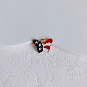 Macro shot of gold-plated butterfly pendant with American flag pattern for DIY jewelry