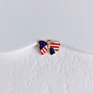 Detail of USA flag bow pendant in gold alloy with red white blue enamel for DIY jewelry