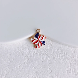 Macro detail of alloy windmill pendant with American flag pattern for DIY jewelry