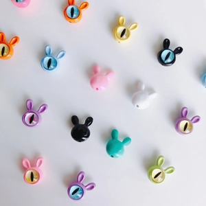 Colorful cute rabbit beads with eye design for DIY jewelry making on white background