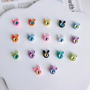 Detailed view of colorful rabbit-shaped beads with realistic eyes for DIY jewelry crafts
