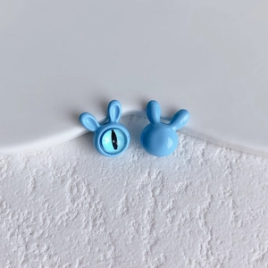 Macro shot of light blue rabbit ear beads with cat eye glass for DIY jewelry