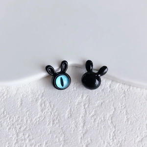 Close-up of cute black rabbit alloy beads with blue cat-eye stone detail for DIY jewelry