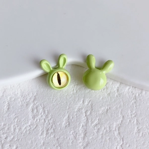 Macro shot of cute light green rabbit beads with glossy enamel finish for DIY jewelry