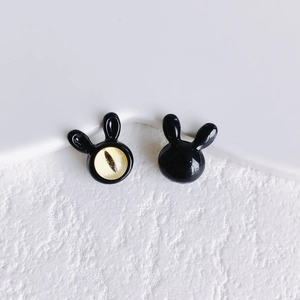 Detail view of cute black rabbit alloy beads with a polished finish and cat eye stone inlay