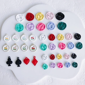 Close-up of colorful flower pendants and poker charms for DIY jewelry making