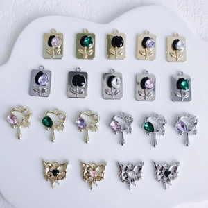 Assorted alloy jewelry charms featuring tulips, hearts and butterflies for DIY crafts