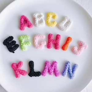 Detailed view of colorful 3D resin letters with rose floral relief for DIY crafts