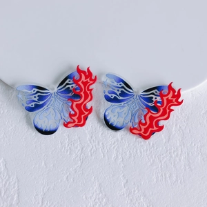 Detail of red and blue gradient acrylic butterfly charms with flame pattern and hanging holes