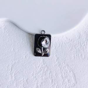 Detail of silver rectangle pendant with black tulip motif and teardrop crystal inlay