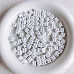 Macro shot of white 2x2 building block style beads for DIY jewelry making accessories