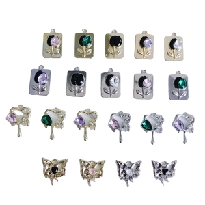 DIY jewelry charms in heart and butterfly shapes with colorful rhinestones on white base