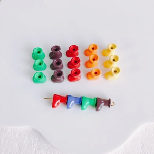 Macro shot of colorful macaroon mini boot charms with pre-drilled holes for DIY jewelry making