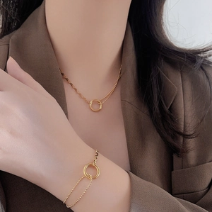 Minimalist gold geometric circle necklace and bracelet set with layered chain design
