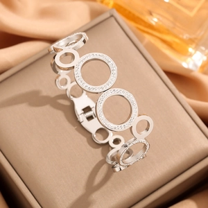 Silver hollow circle bangle with crystal inlay in a luxury jewelry display setting