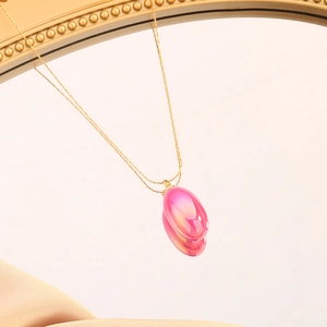 Elegant gold titanium necklace with a pear-shaped pink iridescent teardrop pendant