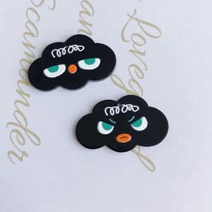 Macro view of cloud-shaped resin charms with quirky facial expressions and matte finish