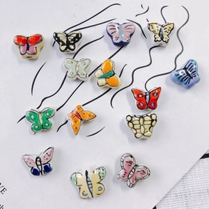 Macro shot of colorful ceramic butterfly beads for DIY jewelry making and handmade crafts