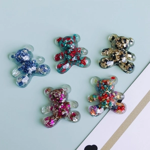 Detailed view of five colorful 3D resin bears with sparkling glitter for DIY crafts