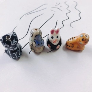 Hand-painted ceramic animal beads featuring cat, monkey, and rabbit designs for DIY jewelry