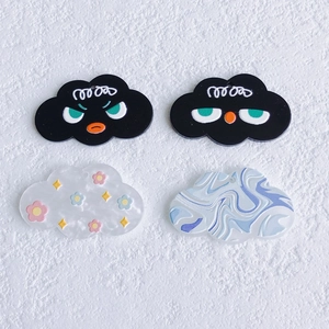 Detailed view of cloud-shaped resin charms featuring oil painting and emoji designs