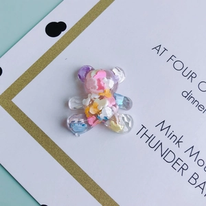 Close-up of clear resin bear DIY charms with colorful macaron filler for crafts