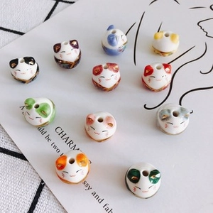 Macro shot of 11 colorful ceramic lucky cat beads for DIY jewelry making accessories