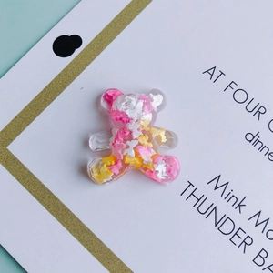 Detailed view of resin bear charms with colorful glitter fillings for DIY accessories