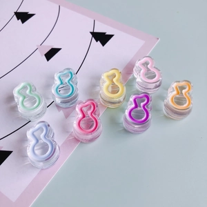 Detail of transparent 8-shaped acrylic charms with colorful macaron edge outlines