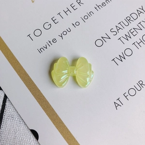 Close-up of translucent yellow resin bow accessory with detailed radial textures for DIY crafts