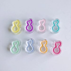 Flat lay of colorful acrylic music note charms in eight candy colors for DIY jewelry making