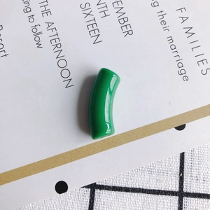 Detail view of a glossy green curved resin tube bead for DIY necklace and bracelet crafts