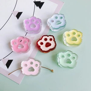 Close-up of colorful resin bear paw beads with horizontal holes for DIY jewelry making