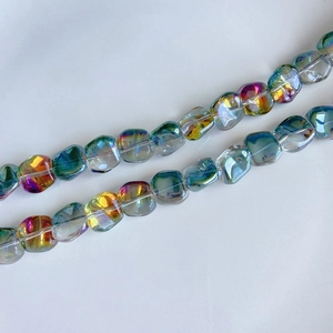 Close-up of iridescent square glass beads for DIY jewelry with colorful rainbow finish