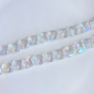 Macro shot of iridescent laser square glass beads with colorful rainbow finish for DIY jewelry