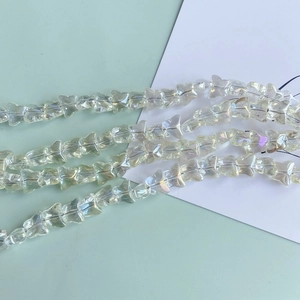 Macro detail of iridescent butterfly glass beads with holographic finish for DIY jewelry