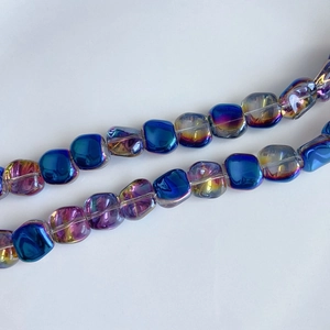 Macro shot of iridescent laser glass square beads for DIY jewelry in blue and purple