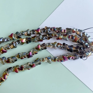 Macro detail of iridescent butterfly glass beads with rainbow AB coating for jewelry DIY