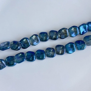 Detailed view of iridescent laser blue glass square beads for DIY jewelry making