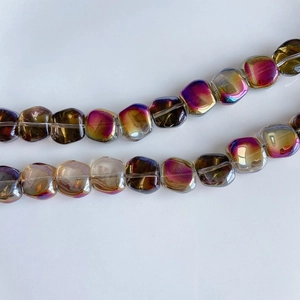 Macro detail of iridescent laser glass square beads with amber and purple gradients