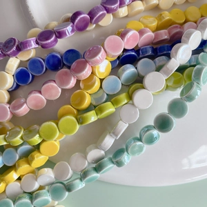 Colorful flat round ceramic beads in pastel shades for DIY necklace and bracelet jewelry