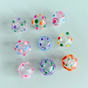 Macro detail of colorful polka dot glass beads with center holes for DIY jewelry making