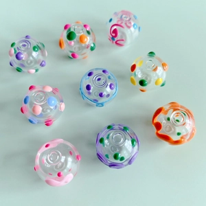 Detailed view of colorful dotted glass beads for handmade jewelry DIY projects