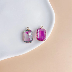 Detailed close-up of geometric faceted crystal pendants with gold-plated copper edges