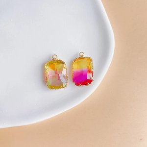 Macro detail of rectangular gradient crystal pendants in gold plated claw settings