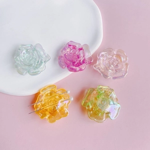 Colorful iridescent acrylic rose flower DIY charms with silver pins on a white tray