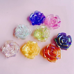 Flat lay of 8 colorful iridescent acrylic rose flower charms for DIY phone case decor