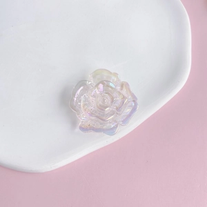 Macro detail of iridescent acrylic rose flower charm with colorful electroplated finish