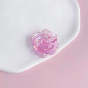 Macro detail of translucent pink iridescent acrylic rose charms for DIY jewelry and phone cases