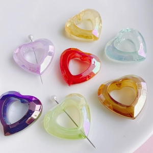 Colorful faceted hollow heart resin beads in various iridescent tones for DIY jewelry making